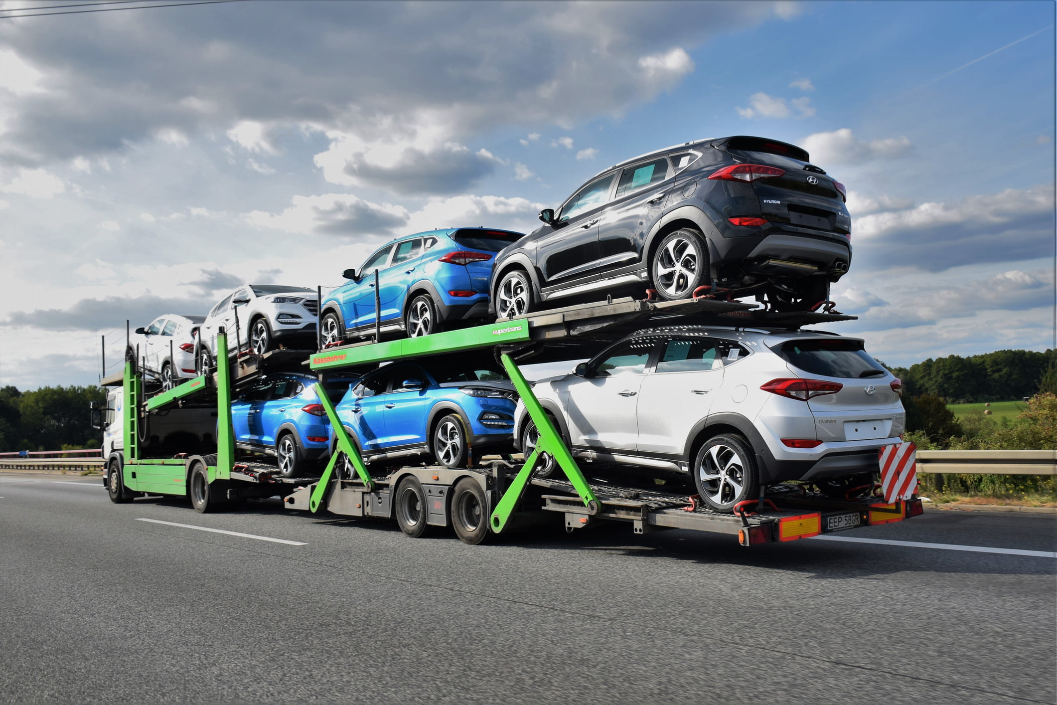 Berlin, Germany - September 20th, 2016: Kassbohrer car transporter driving on the highway. This car transporter has 7 Hyundai Tucson (from Czech factory) cars on board. The Kassbohrer car transporters are the ones of the most popular transporters in Europe.